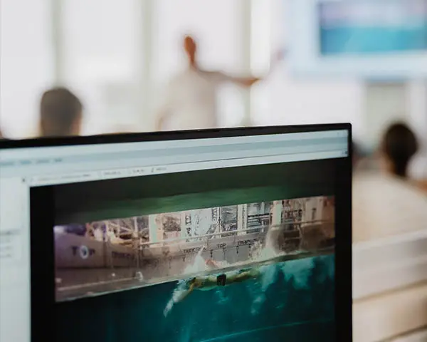 Screen of the computer showing person swimming in the flume channel